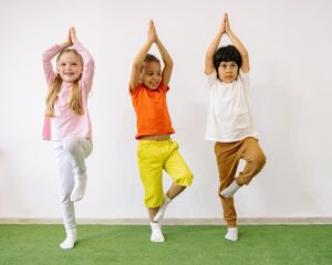 Kids doing tree pose yoga