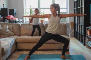 mom and daughter doing warrior pose